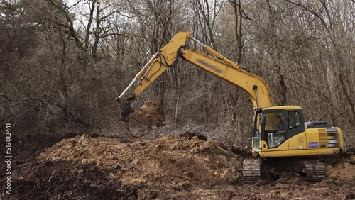 Bucket of backhoe digging soil at construction site. Crawler excavator digging. Excavating machine. Earth moving equipment. Excavation vehicle. Erection business.