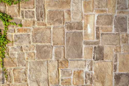 Light stone tiles lying diagonally. A stone wall. A great background for your design.