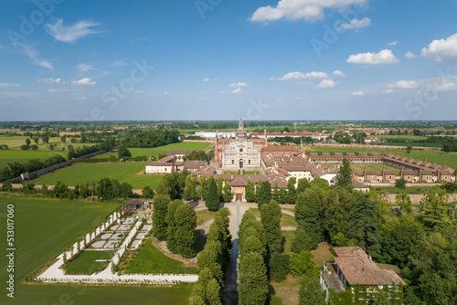 Aerial shot of the Certosa di Pavia at sunny day, built in the late fourteenth century, courts and the cloister of the monastery and shrine in the province of Pavia, Lombardia, Italy