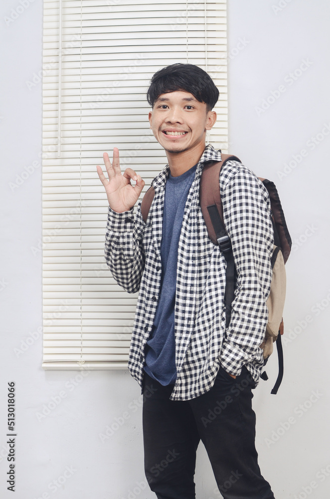 asian student wearing casual clothes doing OK sign asian student wearing casual clothes doing OK sign