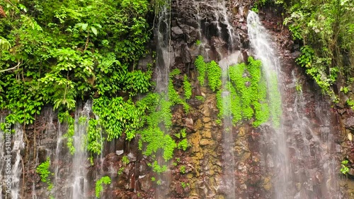 Waterfall in green forest, top view. Tropical Tinago Falls in mountain jungle, Philippines, Mindanao. Waterfall in the tropical forest. photo