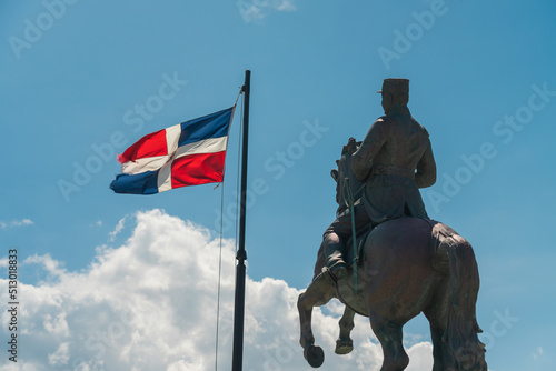 Closeup shot of the General Gregorio Luperon statue and the flag of Dominican Republic photo