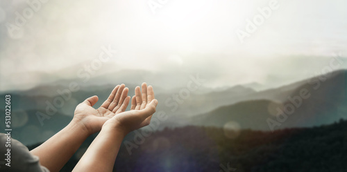 The two hands of a young man who prayed for hope from God Praise God concept. Pray, communicate. Mountain nature background. at sunrise