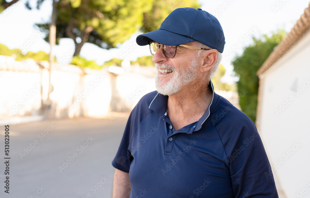 Fototapeta premium Senior grey-haired man smiling happy standing at the city.