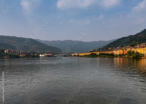 Beautiful view of the Lavasa city on the shore of the lake in India with hills in the background photo