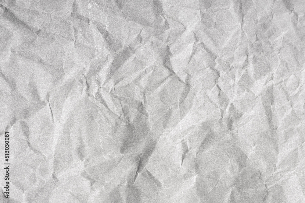 Creased paper background texture. Gray color. Full frame