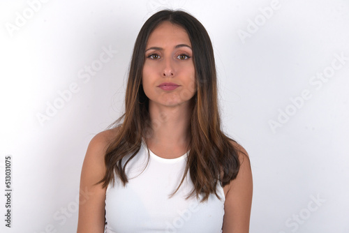young beautiful caucasian woman wearing white Top over white background, depressed and worry for distress, crying angry and afraid. Sad expression. © Jihan