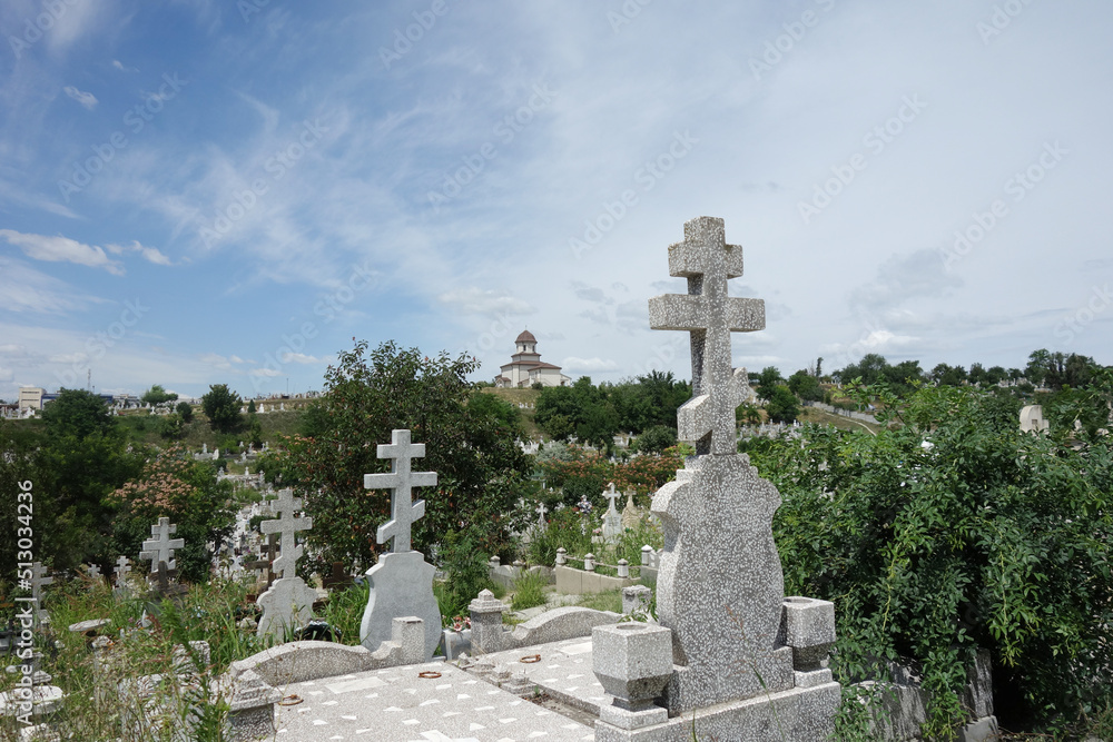 orthodox cemetery in a sunny summer day with orthodox and russian crosses and church orthodox cemetery in a sunny summer day with orthodox and russian crosses and church