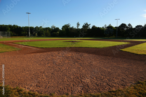 A wide angle view of baseball field shot early in the morning.