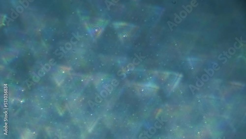 Magic background from triangles. Strong blur. Bokeh.Natural video. Shiny and shimmery particles. Slow motion video