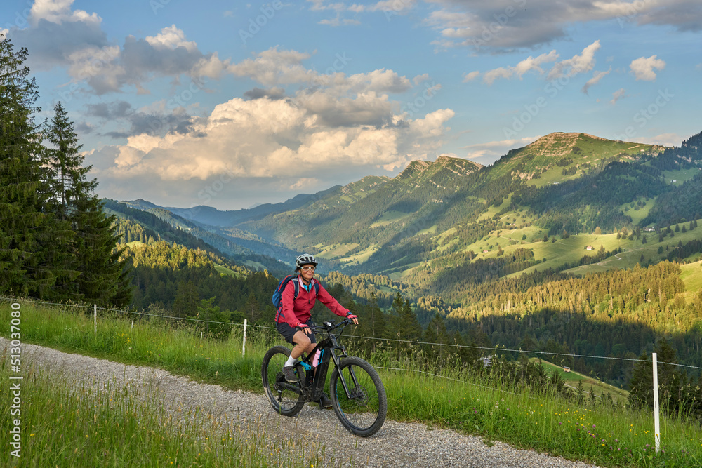 pretty senior woman riding her electric mountain bike on the mountains above Oberstaufen with Nagelfluh mountain chain in background, Allgau Alps, Bavaria Germany
pretty senior woman riding her electric mountain bike on the mountains above Oberstaufen with Nagelfluh mountain chain in background, Allgau Alps, Bavaria Germany