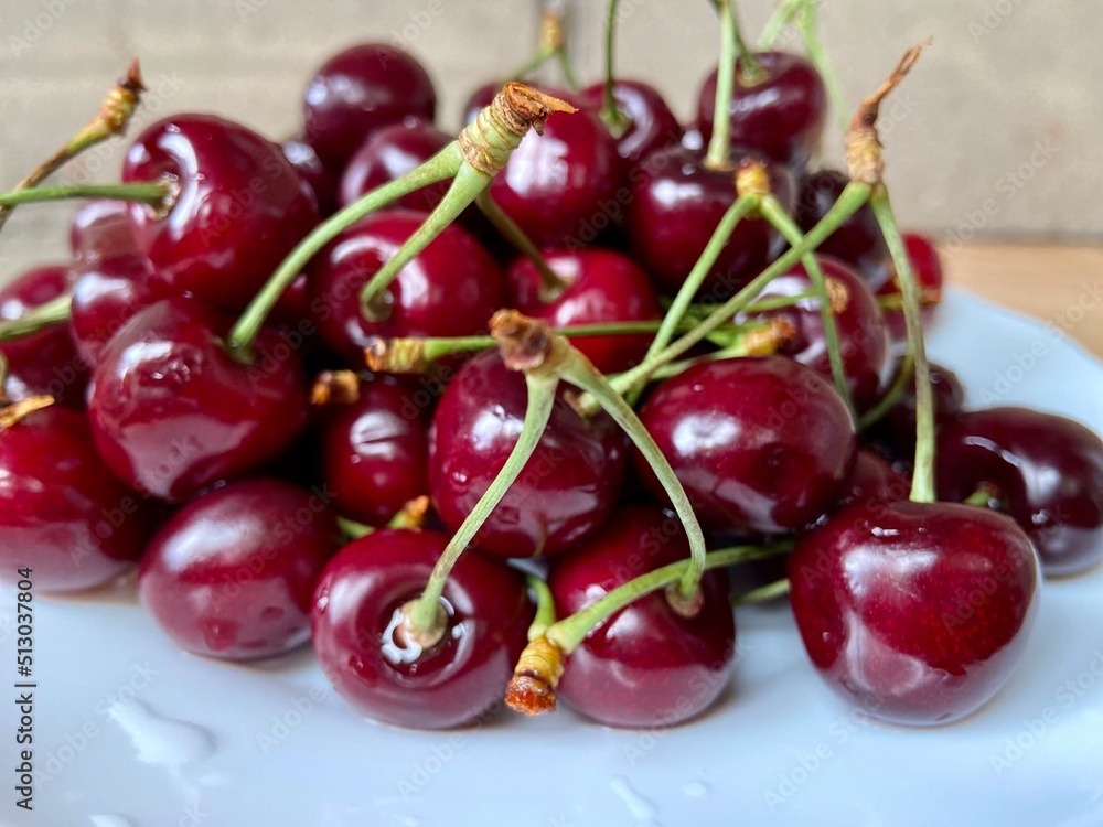 Cherries on a plate. Sweet cherry with water drops close-up. Cherry background. Cherries on a plate. Sweet cherry with water drops close-up. Cherry background.