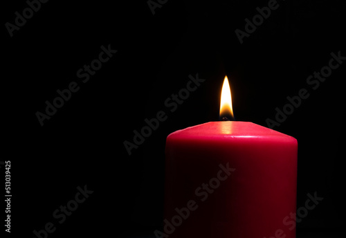 Black background with a burning candle