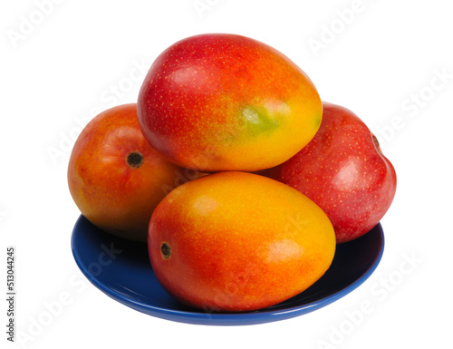Red ripe sweet juicy delicious mango on a blue plate, isolated on white background