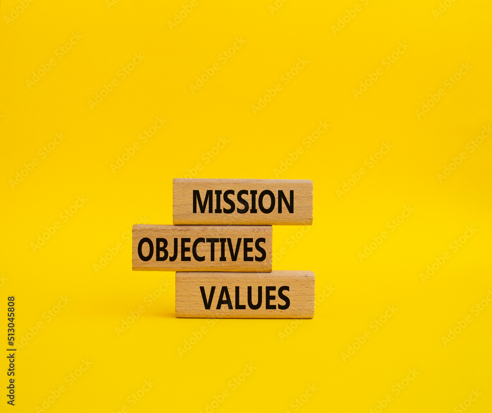Mission Objectives Values symbol. Concept words Mission Objectives Values on wooden blocks. Beautiful yellow background. Business and Mission Objectives Values concept. Copy space Mission Objectives Values symbol. Concept words Mission Objectives Values on wooden blocks. Beautiful yellow background. Business and Mission Objectives Values concept. Copy space