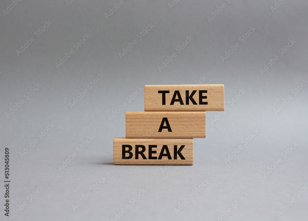Take a break symbol. Concept words 'Take a break' on wooden blocks. Beautiful grey background. Business and Take a break concept. Copy space. Take a break symbol. Concept words 'Take a break' on wooden blocks. Beautiful grey background. Business and Take a break concept. Copy space.