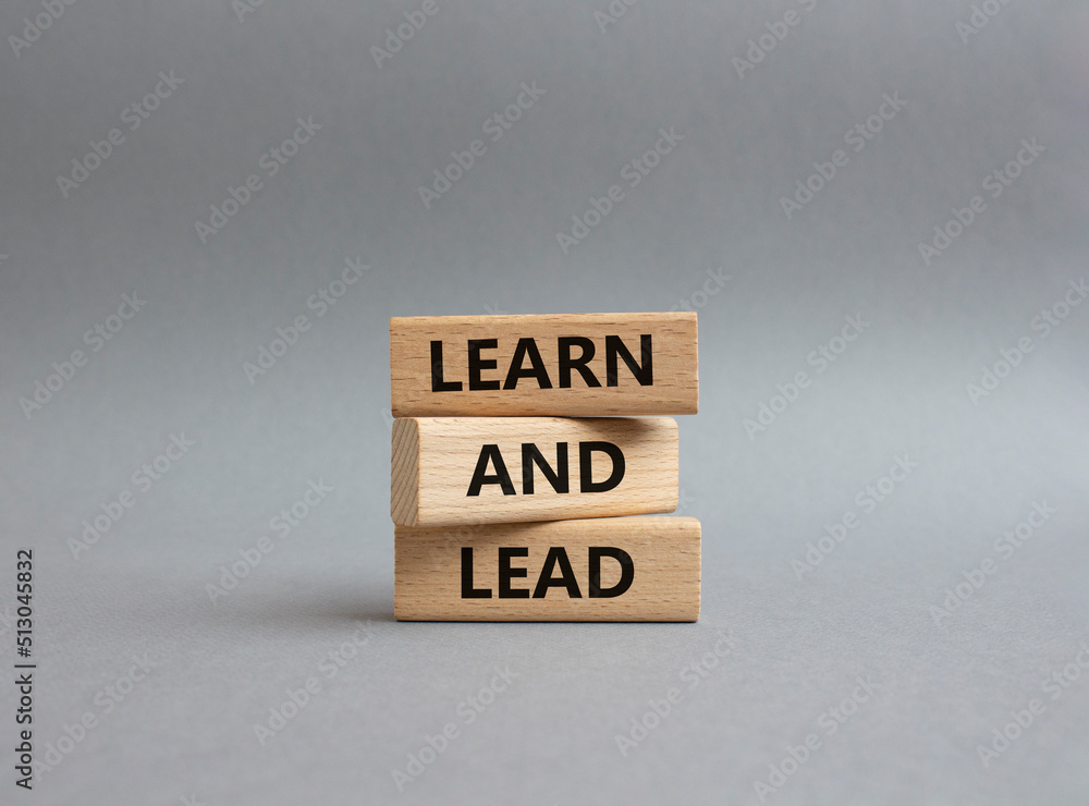 Learn and lead symbol. Concept words 'Learn and lead' on wooden blocks. Beautiful grey background. Business and Learn and lead concept. Copy space. Learn and lead symbol. Concept words 'Learn and lead' on wooden blocks. Beautiful grey background. Business and Learn and lead concept. Copy space.