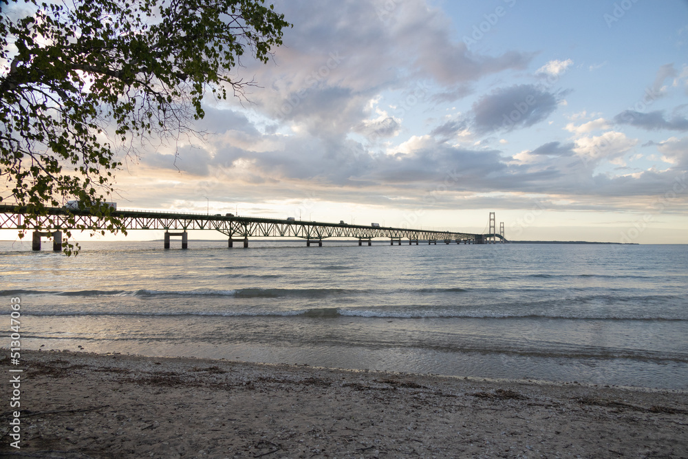 Sand beach and Mackinac Bridge at sunset, Michigan, USA