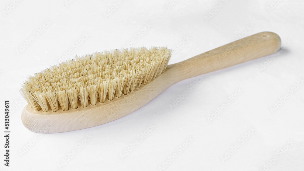 Natural bristle brush with wooden handle for dry massage isolated on white background Natural bristle brush with wooden handle for dry massage isolated on white background