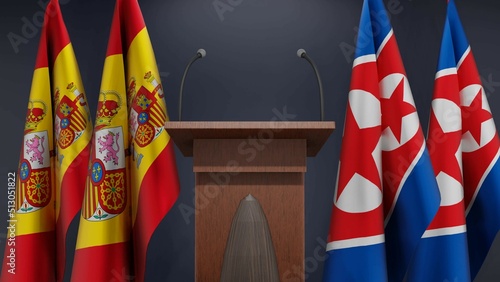 Flags of Spain and North Korea at international meeting or negotiations press conference. Podium speaker tribune with flags and coat arms. 3d rendering