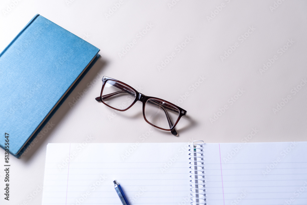 notebook, glasses and blue book, copy space, reading, myopic eyesight, good life concept, selective focus notebook, glasses and blue book, copy space, reading, myopic eyesight, good life concept, selective focus