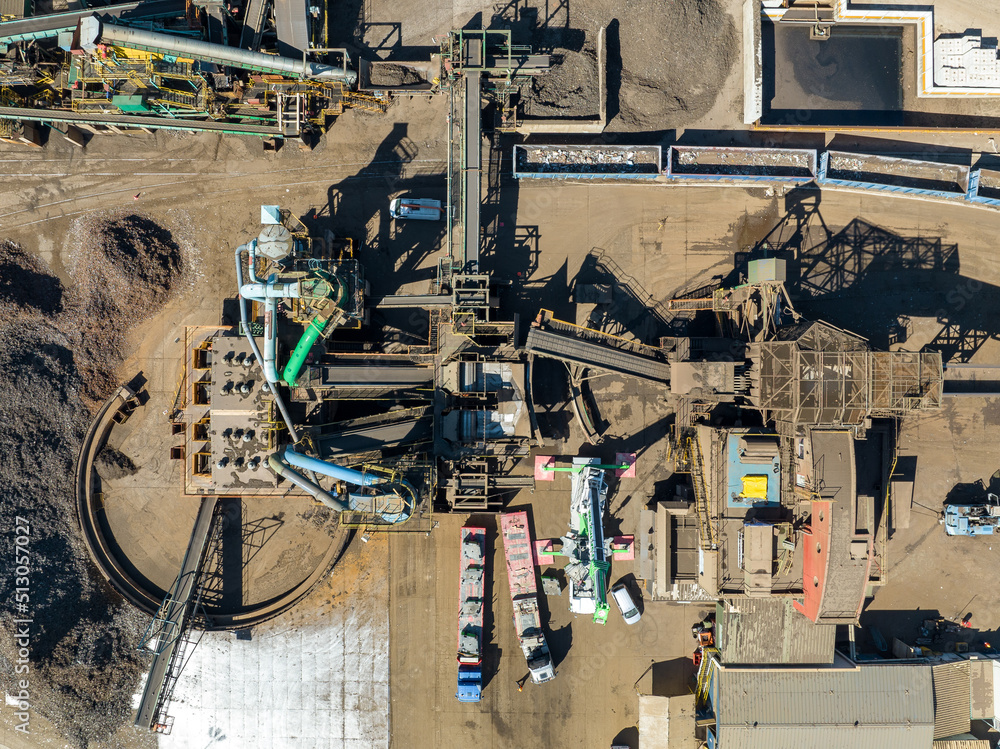 Scrap Metal Recycling. Aerial View of Industrial Scrap Processing. Heavy Machinery Working on Recycling Process.