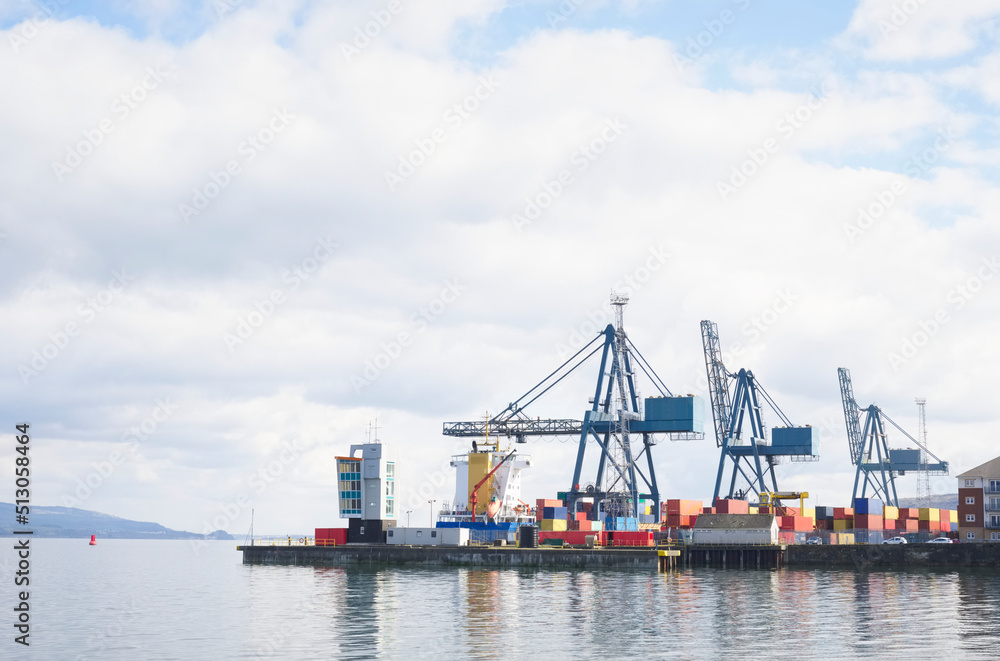 Cranes at logistics port terminal for offloading containers Cranes at logistics port terminal for offloading containers