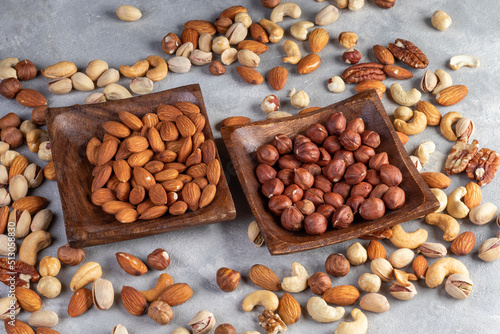 Cashew, almond, peanut, walnut nuts in a wooden bowl.