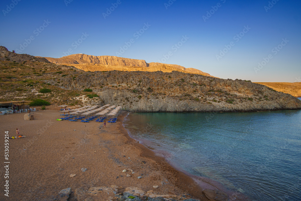 Fototapeta premium View of the famous rocky beach Melidoni in Kythira island at sunset. Amazing scenery with crystal clear water and a small rocky gulf, Mediterranean sea, Greece, Europe.