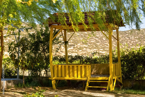 Photo Handcrafted, yellow painted arbour made of wood