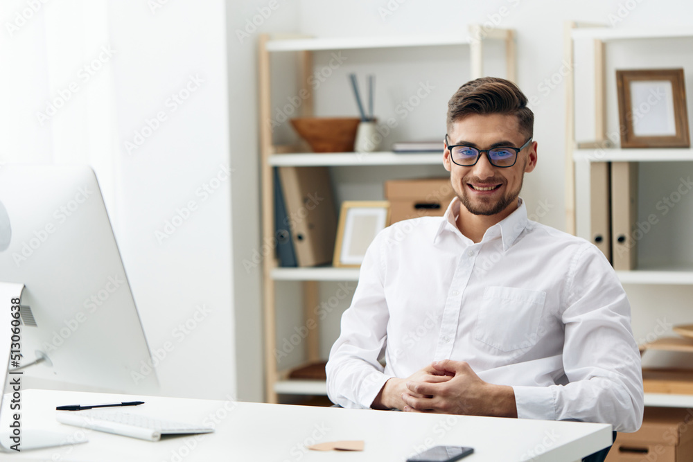 manager wearing glasses sits at a desk office worked office manager wearing glasses sits at a desk office worked office