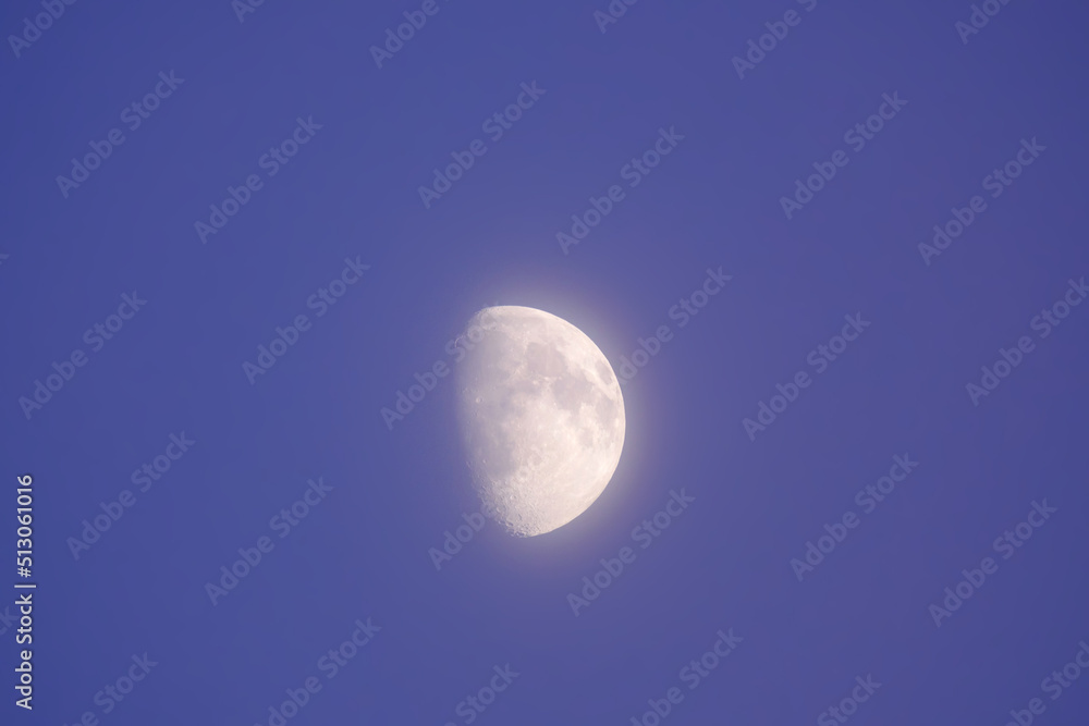 Moon disk in the evening blue sky close-up Moon disk in the evening blue sky close-up