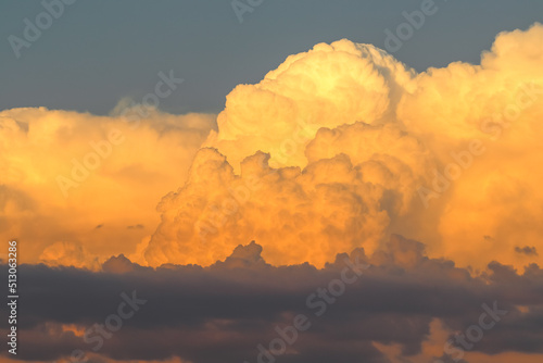 Orange cumulonimbus cloud at sunset