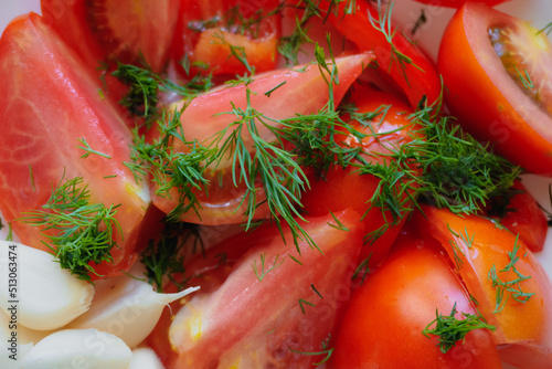 Sliced tomatoes with garlic close up.