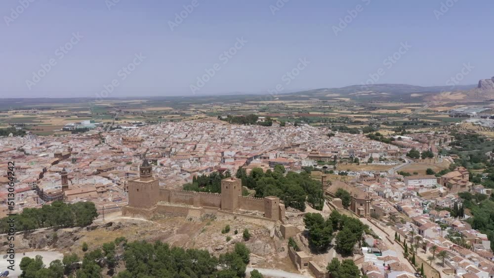 Perspective from above of city of Antequera. Drone rotating around the Castle of the city. Wide perspective of the city, view of the church and small streets. Typically white Andalusian city. Perspective from above of city of Antequera. Drone rotating around the Castle of the city. Wide perspective of the city, view of the church and small streets. Typically white Andalusian city.