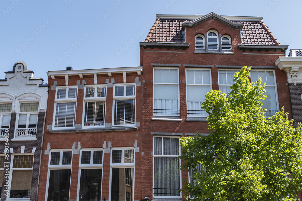Fototapeta premium Canal view with old traditional Dutch houses in Leiden on beautiful sunny day. Leiden, North Holland, the Netherlands.