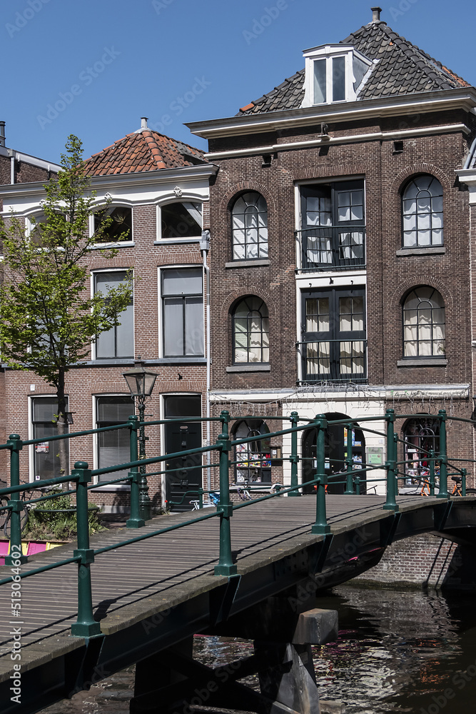 Canal view with old traditional Dutch houses in Leiden on beautiful sunny day. Leiden, North Holland, the Netherlands.