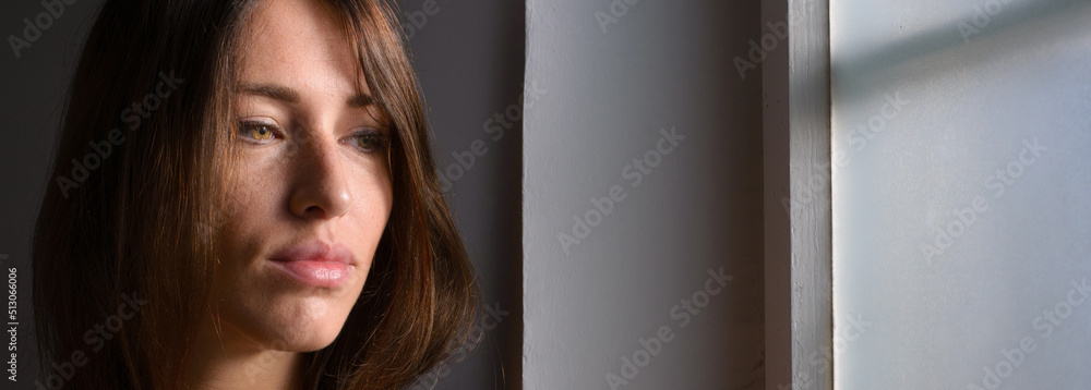 Portrait of beautiful young sexy woman looking through window Portrait of beautiful young sexy woman looking through window