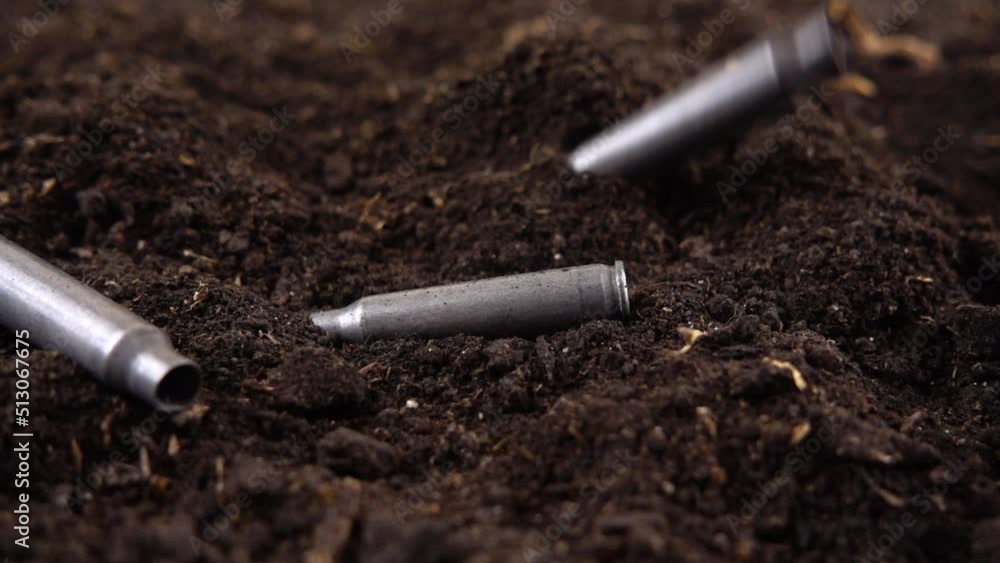 Bullet casings fall to the ground. Slow motion. Bullet casings fall to the ground. Slow motion.