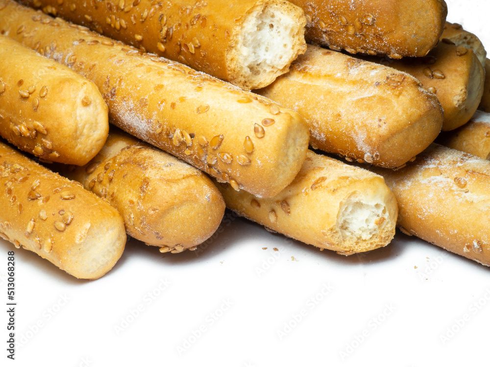 Sesame biscuits on a white background. Biscuits are elongated in the form of sticks. Bread products. Flour products for snacks. Lots of homemade cakes. Healthy food. Sesame biscuits on a white background. Biscuits are elongated in the form of sticks. Bread products. Flour products for snacks. Lots of homemade cakes. Healthy food.
