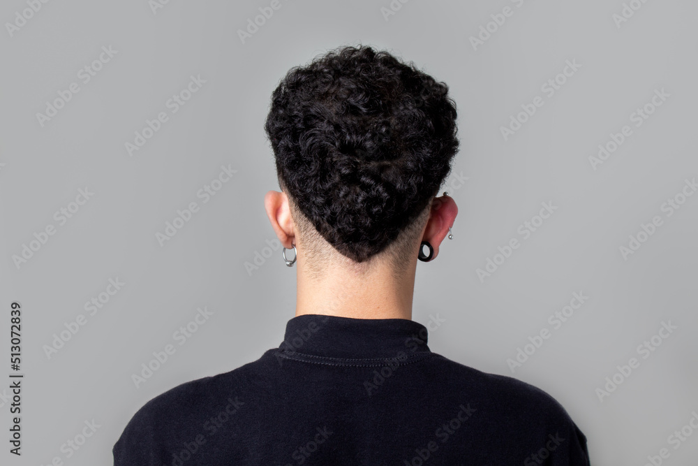 Stockfoto Young man from back with curly taper fade haircut