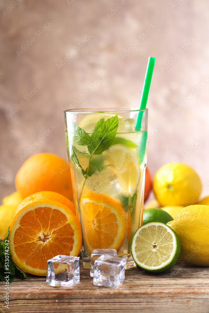 Homemade lemonade in a jar, limes, lemons and mint on a wooden board. Made from lemon and mint. Homemade lemonade in a jar, limes, lemons and mint on a wooden board. Made from lemon and mint.