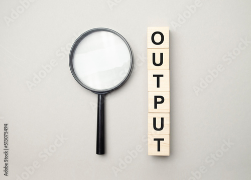 the wooden cubes with the word output and magnifier