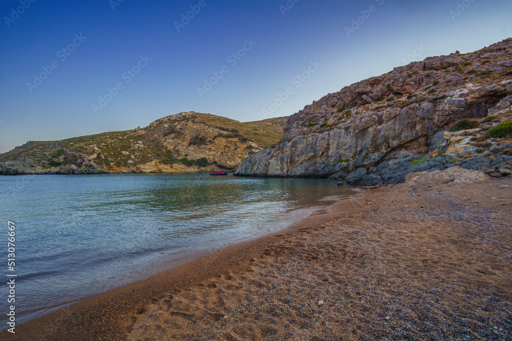 View of the famous rocky beach Melidoni in Kythira island at sunset. Amazing scenery with crystal clear water and a small rocky gulf, Mediterranean sea, Greece, Europe.