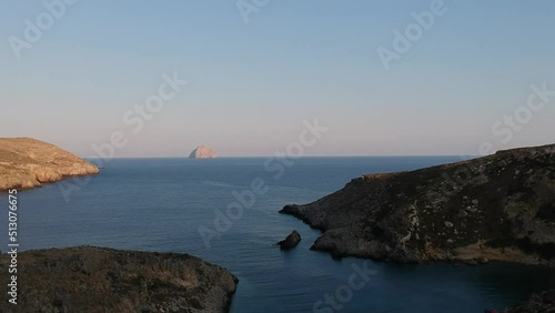 View of the famous rocky beach Melidoni in Kythira island at sunset. Amazing scenery with crystal clear water and a small rocky gulf, Mediterranean sea, Greece, Europe. photo
