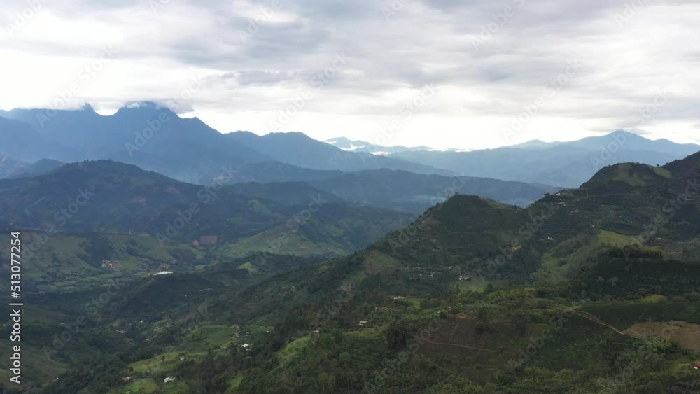 Drone shot flying over green landscape in Andes Region of Antioquia, Colombia. Sown, coffee, plantain, country roads, farms. Cloudy day. Drone shot flying over green landscape in Andes Region of Antioquia, Colombia. Sown, coffee, plantain, country roads, farms. Cloudy day.