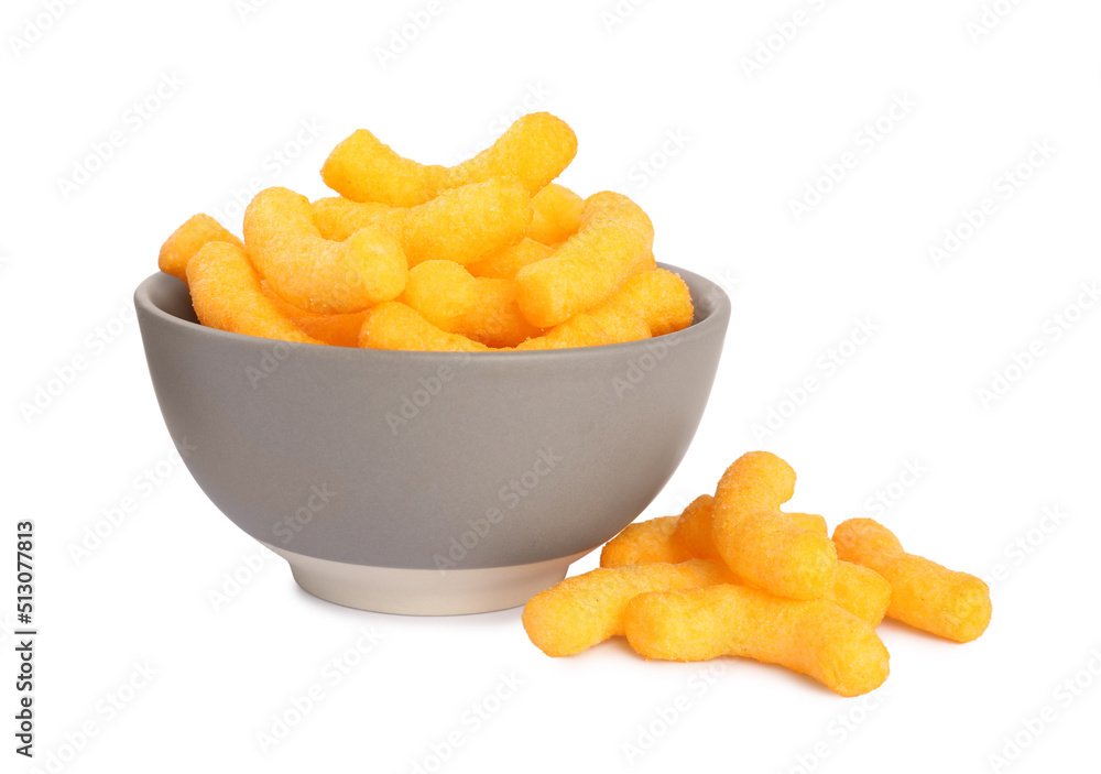 Many tasty cheesy corn puffs in bowl isolated on white Many tasty cheesy corn puffs in bowl isolated on white