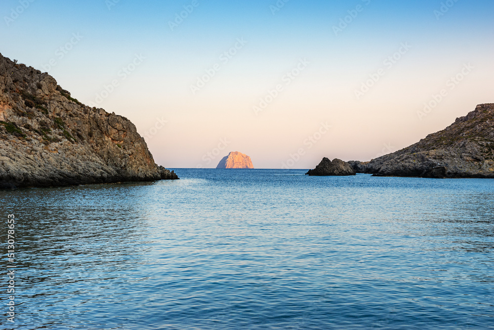 Naklejka premium View of the famous rocky beach Melidoni in Kythira island at sunset. Amazing scenery with crystal clear water and a small rocky gulf, Mediterranean sea, Greece, Europe.