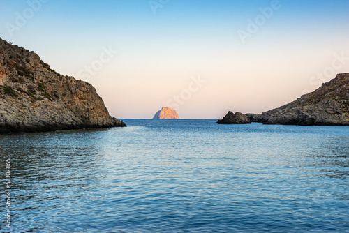 View of the famous rocky beach Melidoni in Kythira island at sunset. Amazing scenery with crystal clear water and a small rocky gulf  Mediterranean sea  Greece  Europe.
