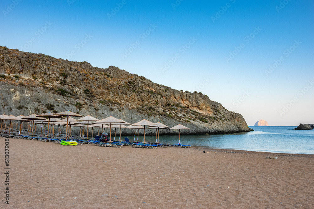 View of the famous rocky beach Melidoni in Kythira island at sunset. Amazing scenery with crystal clear water and a small rocky gulf, Mediterranean sea, Greece, Europe.